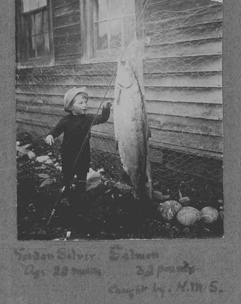Dr Gordon L. Silver admires a 33 lb. St. Mary's salmon caught by his father, Dr. Gordon M. Silver